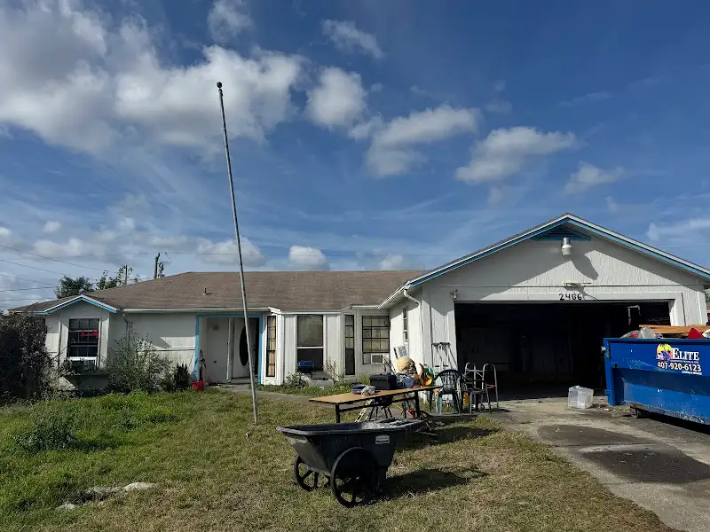 Exterior renovation in progress with dumpster by JM Home Industries