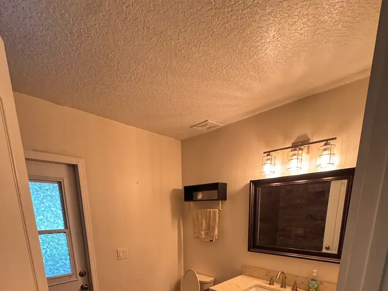 Bathroom with new vanity and light fixture by JM Home Industries
