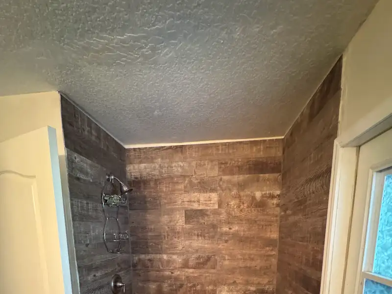 Shower surround with wood-look tile by JM Home Industries