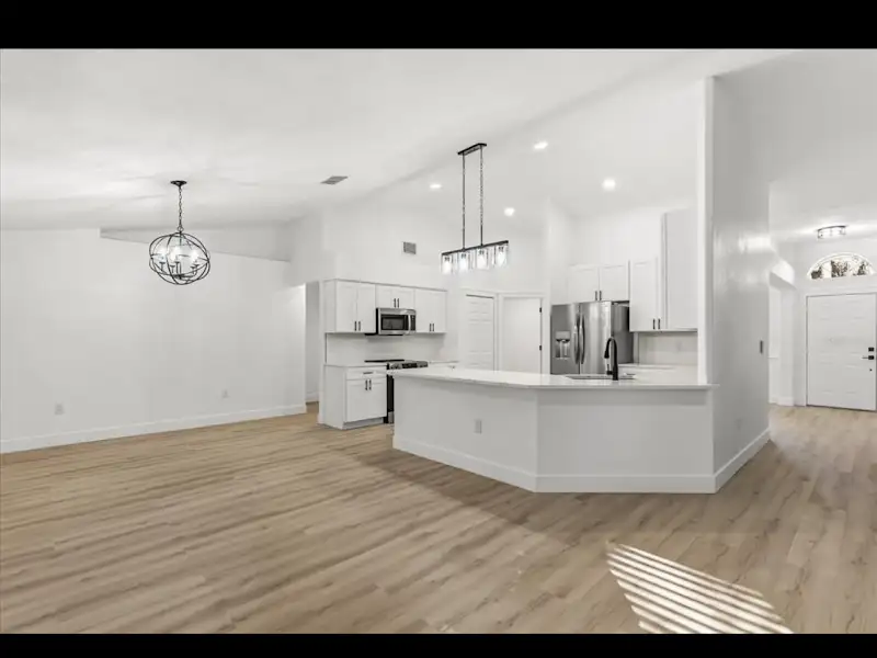 Open concept kitchen and living area by JM Home Industries