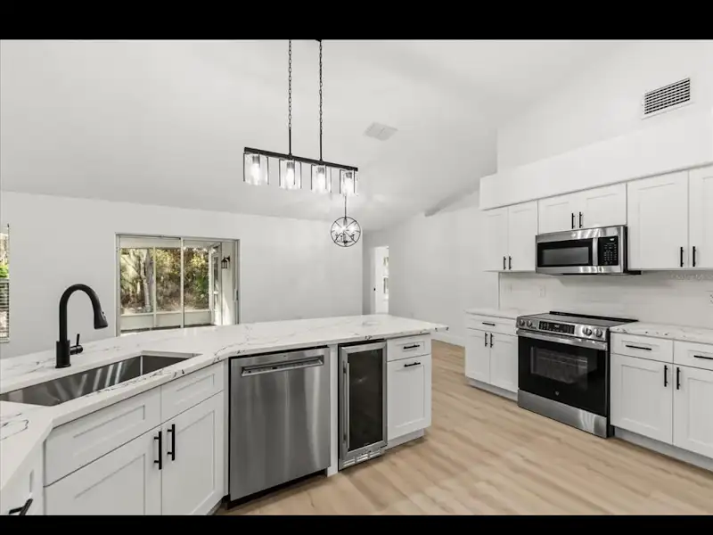 Kitchen renovation with stainless steel appliances by JM Home Industries