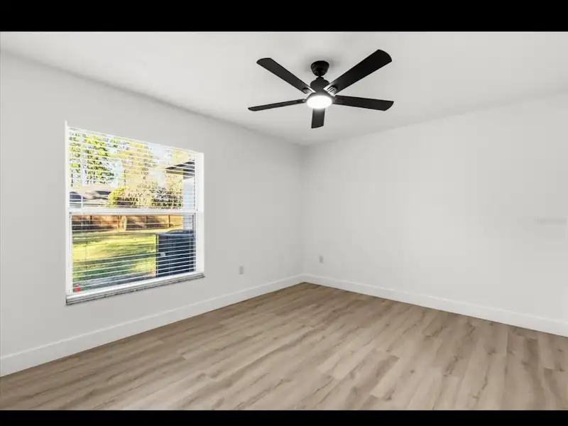 Bedroom with ceiling fan by JM Home Industries