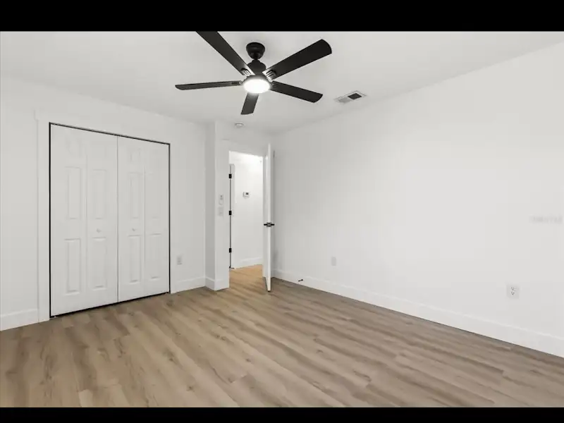 Bedroom with closet and ceiling fan by JM Home Industries